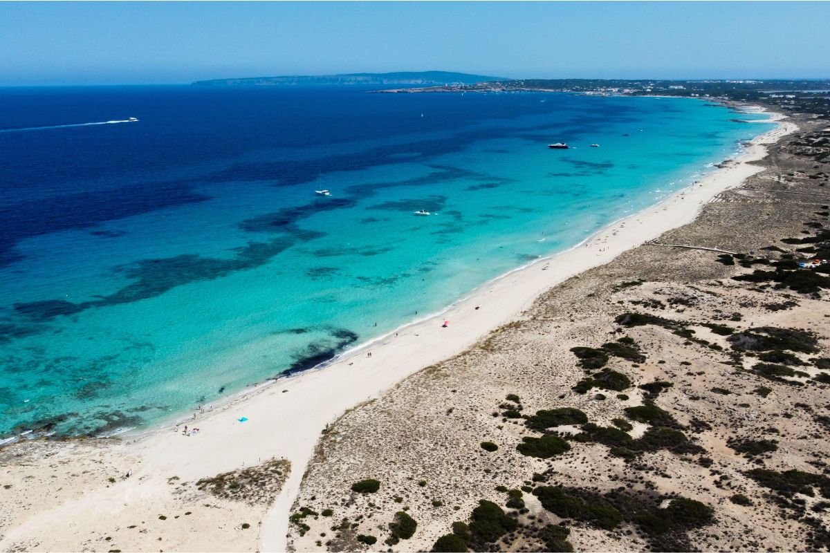 Aerial view of Formentera coastline with clear blue water and white sand beach