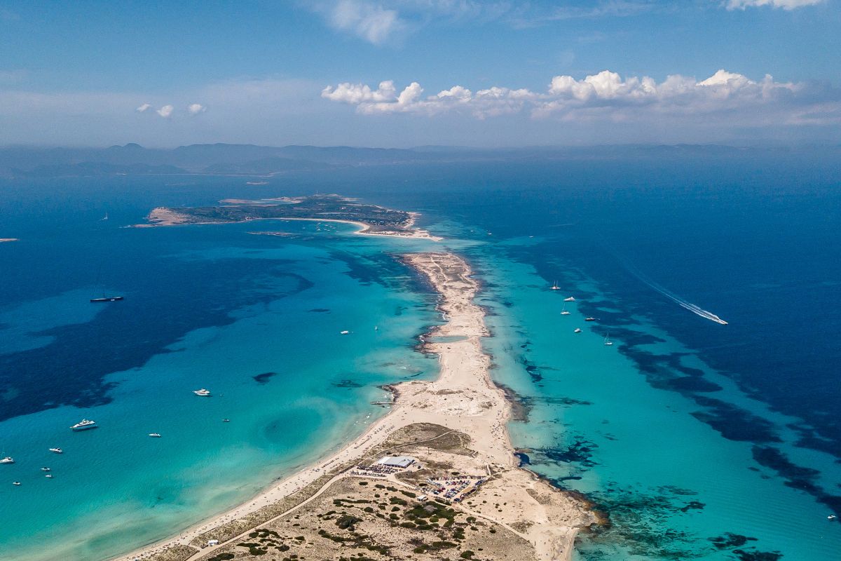 Aerial view of Formentera coastline with crystal-clear turquoise water and white sand beach